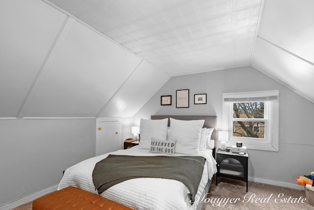 bedroom with vaulted ceiling and carpet