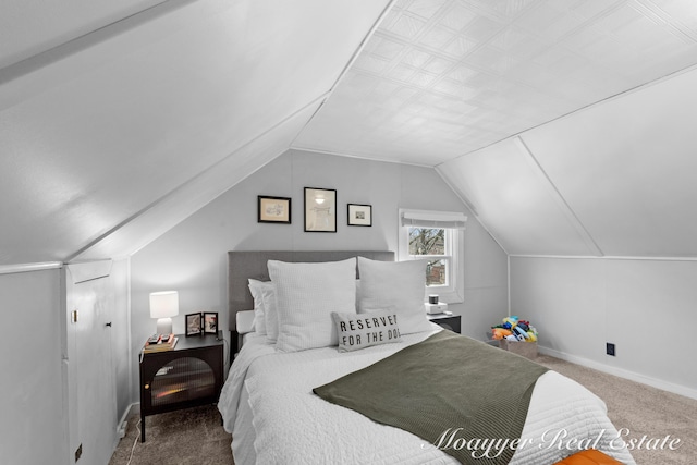 carpeted bedroom featuring lofted ceiling