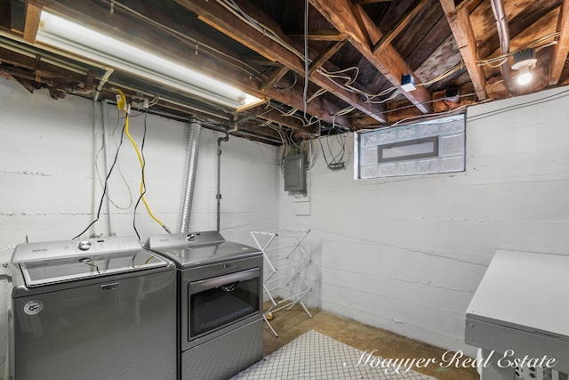 clothes washing area featuring electric panel and washing machine and dryer