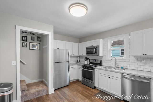 kitchen with white cabinetry, appliances with stainless steel finishes, and sink