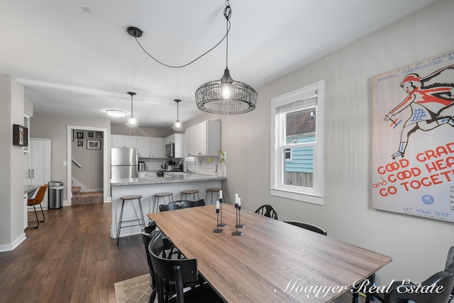 dining room with dark hardwood / wood-style flooring