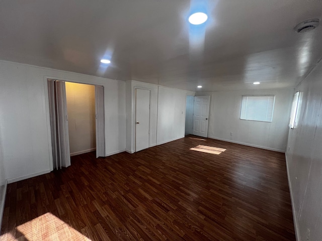 empty room with dark hardwood / wood-style flooring