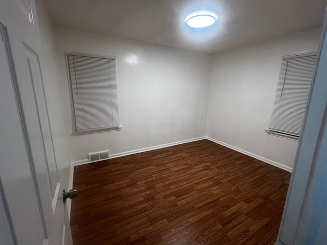 empty room featuring dark wood-type flooring