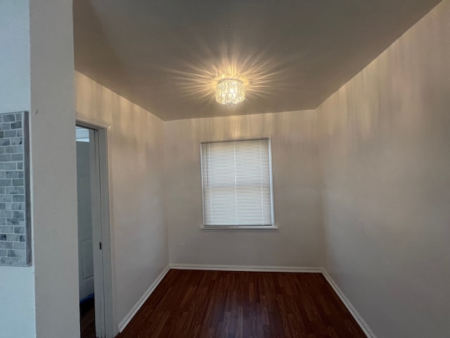 spare room with dark wood-type flooring