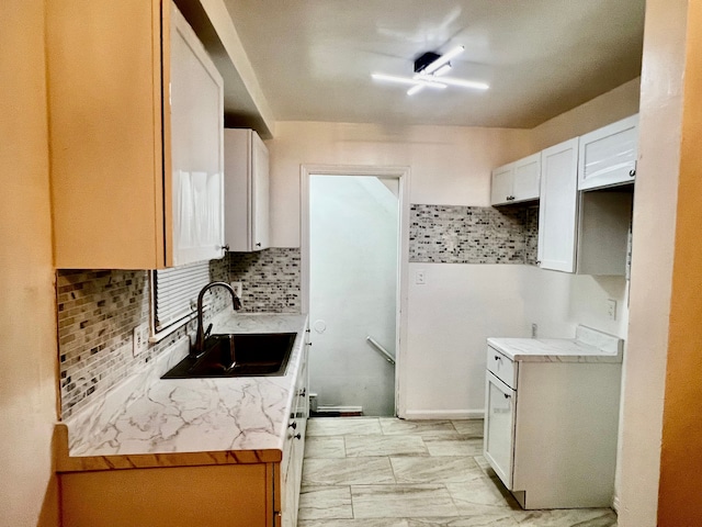 kitchen with white cabinetry, sink, and tasteful backsplash