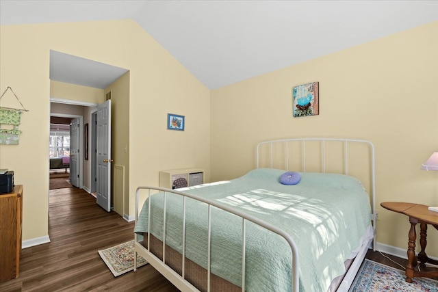 bedroom with lofted ceiling and dark hardwood / wood-style floors