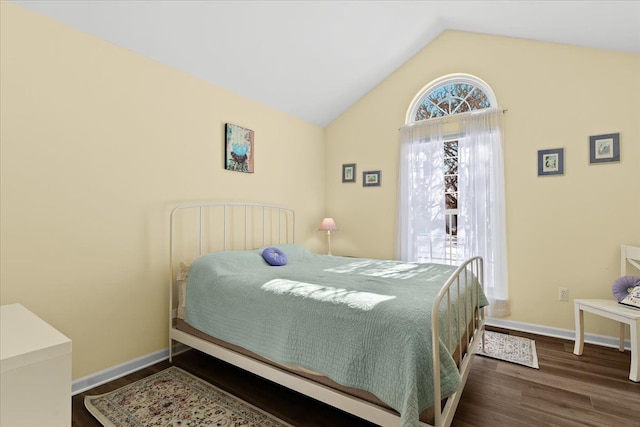 bedroom featuring lofted ceiling and dark wood-type flooring