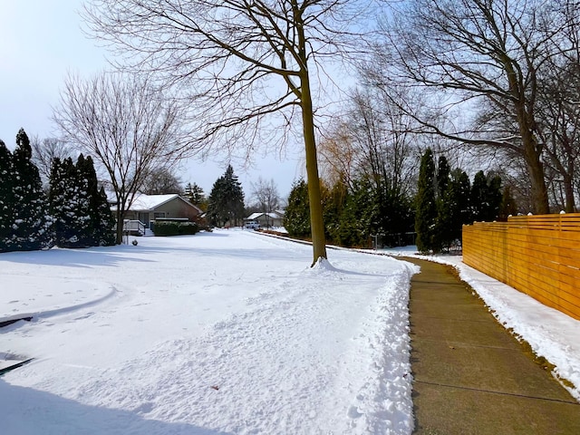 snowy yard with fence