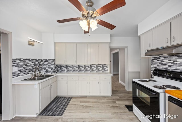 kitchen with electric stove, sink, stainless steel dishwasher, and white cabinets