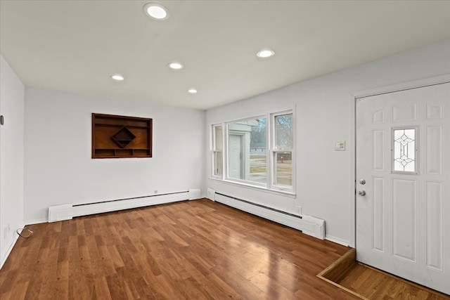 foyer with a baseboard radiator, wood finished floors, and recessed lighting