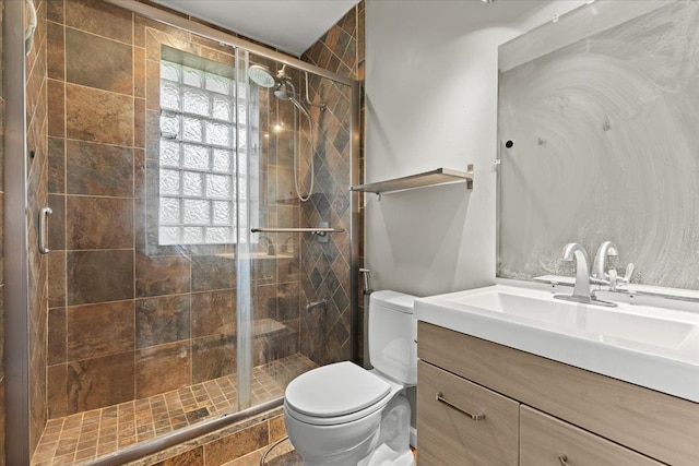 bathroom featuring a shower stall, vanity, and toilet