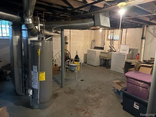 basement featuring sink, water heater, and washing machine and clothes dryer