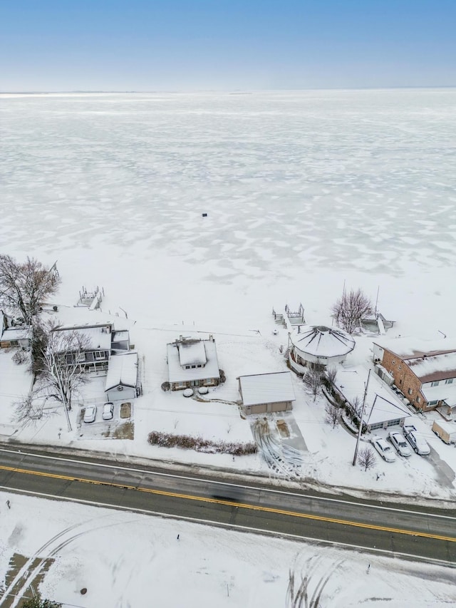 snowy aerial view with a water view