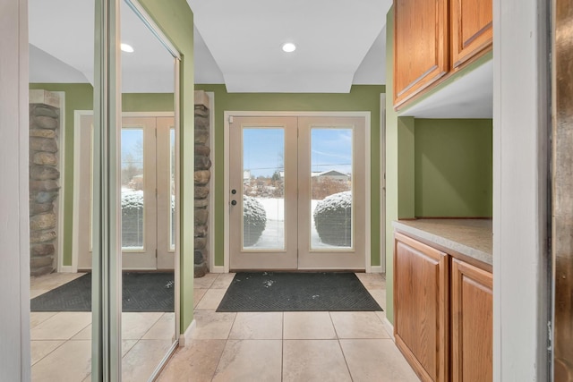 doorway to outside with french doors and light tile patterned flooring