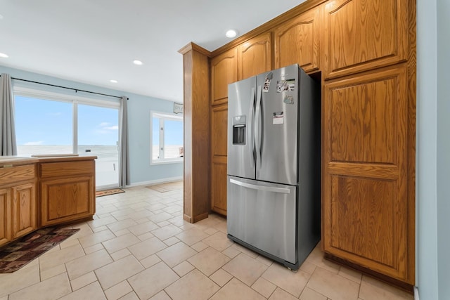 kitchen featuring stainless steel fridge with ice dispenser