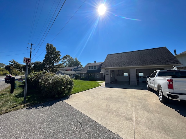 view of front of house with a garage and a front lawn