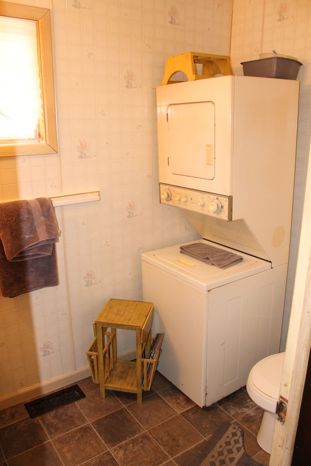 laundry room with stacked washer and dryer