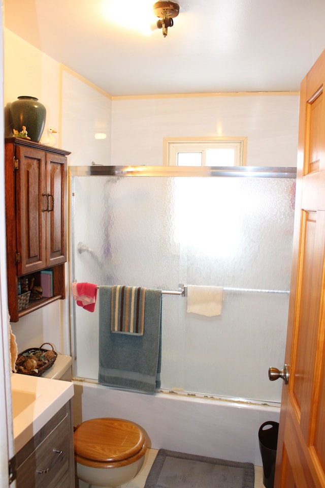 full bathroom with toilet, vanity, and shower / bath combination with glass door