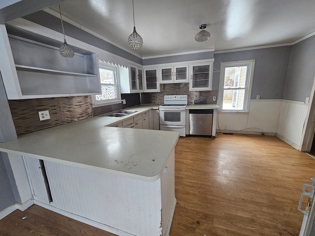 kitchen with pendant lighting, sink, white cabinets, white electric range oven, and kitchen peninsula