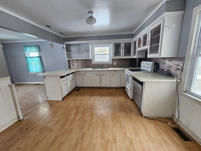 kitchen with white cabinets, decorative light fixtures, white electric stove, kitchen peninsula, and light wood-type flooring