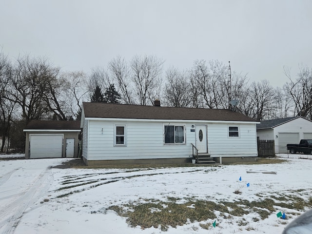 view of front of property with a garage and an outdoor structure