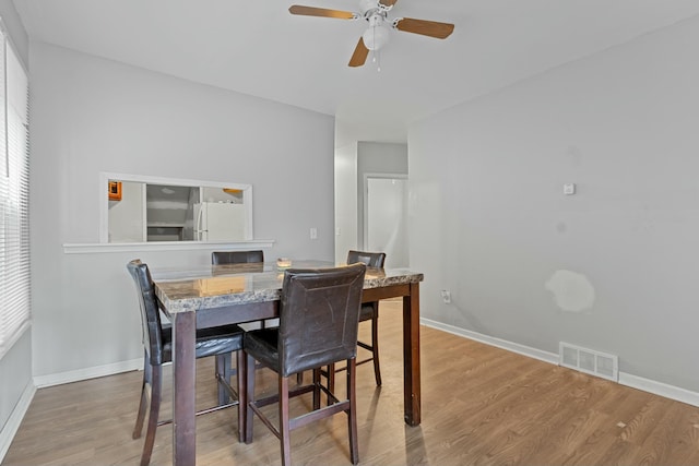 dining area featuring hardwood / wood-style floors, a healthy amount of sunlight, and ceiling fan