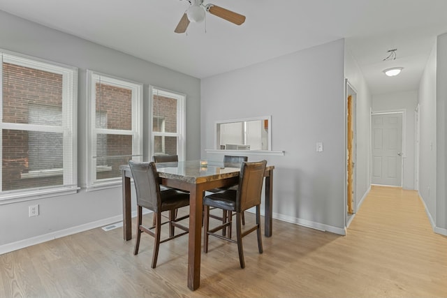 dining room featuring ceiling fan and light hardwood / wood-style flooring