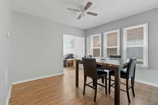 dining area featuring hardwood / wood-style floors and ceiling fan