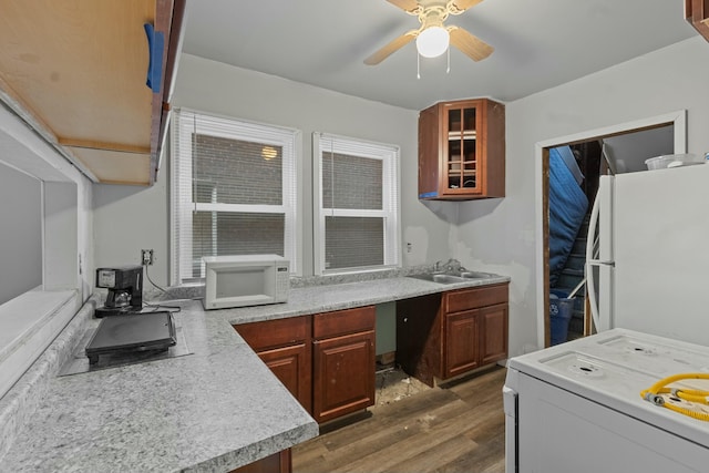 kitchen featuring ceiling fan, white appliances, dark hardwood / wood-style floors, and sink