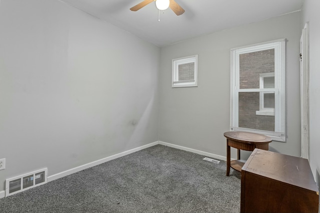 carpeted empty room with plenty of natural light and ceiling fan