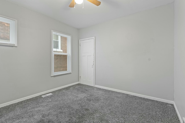 spare room featuring ceiling fan and carpet