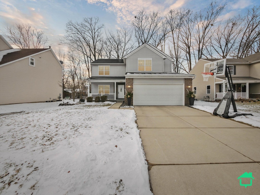 view of property with a porch and a garage