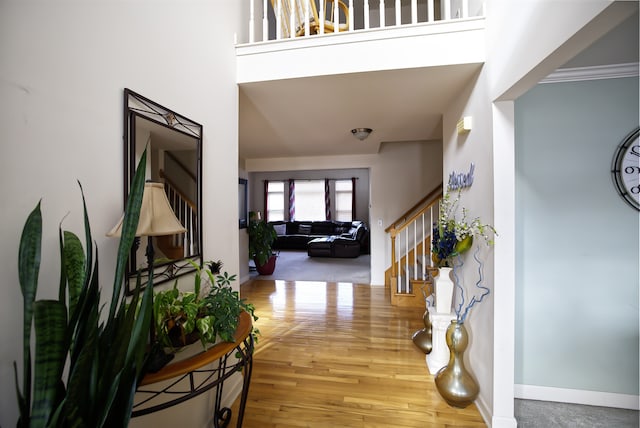 foyer featuring hardwood / wood-style flooring and a high ceiling