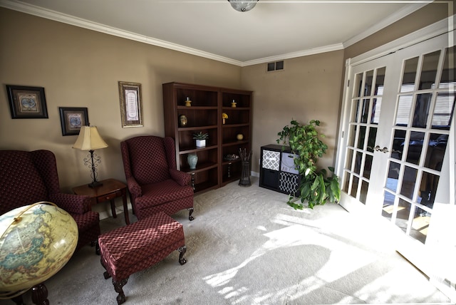 sitting room with ornamental molding, carpet, and french doors