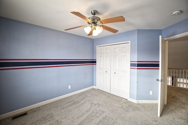 unfurnished bedroom featuring a closet, ceiling fan, and carpet