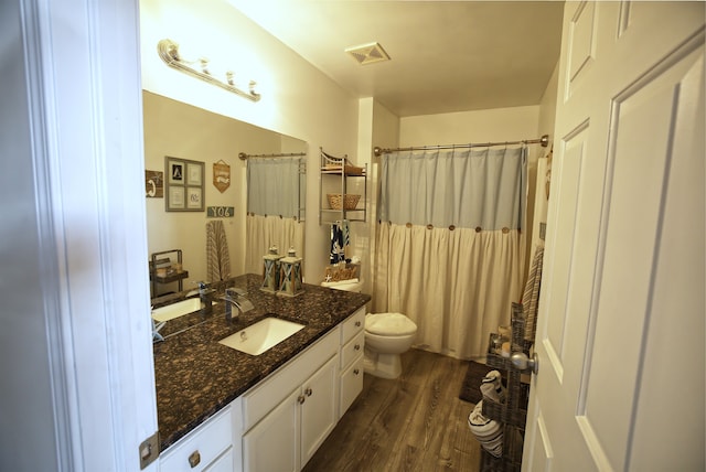 bathroom featuring hardwood / wood-style flooring, vanity, and toilet