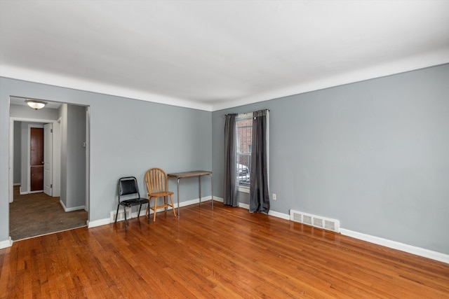 unfurnished room featuring hardwood / wood-style flooring