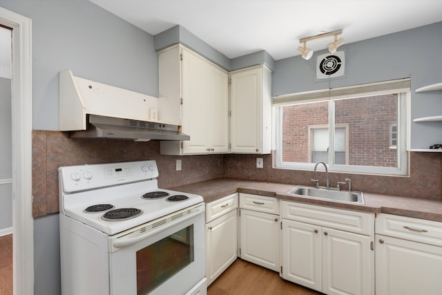 kitchen with sink, white cabinetry, light hardwood / wood-style flooring, electric stove, and backsplash