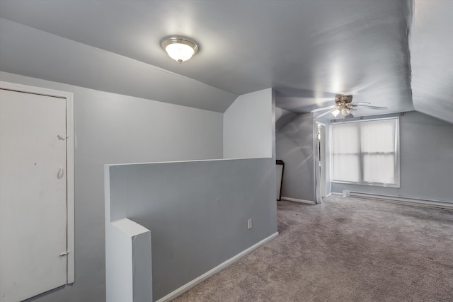 bonus room with light carpet, a baseboard heating unit, and vaulted ceiling