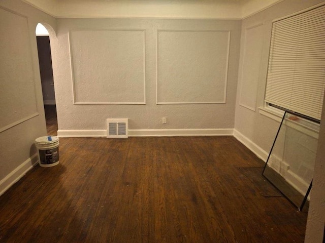 empty room with dark hardwood / wood-style flooring