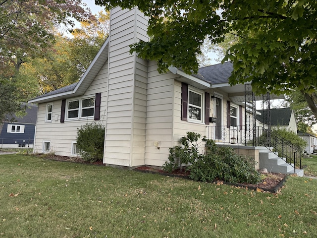 view of side of property with a lawn