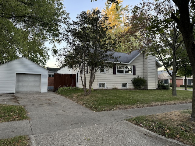 view of front of house with a garage, an outdoor structure, and a front lawn