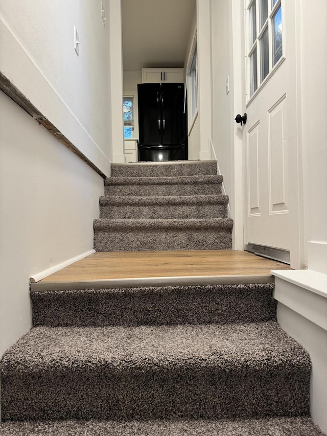 stairs featuring hardwood / wood-style floors