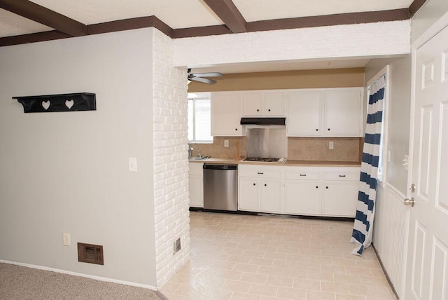 kitchen with white cabinetry, beam ceiling, and stainless steel dishwasher