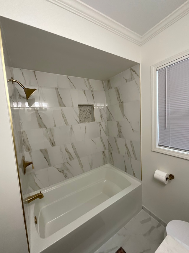 bathroom featuring tiled shower / bath, ornamental molding, and toilet