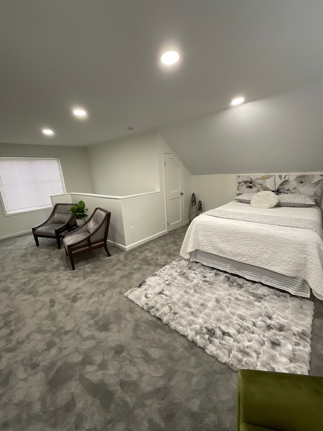 bedroom with lofted ceiling and dark carpet