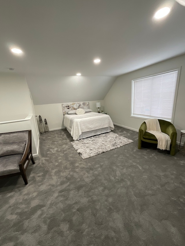 bedroom with vaulted ceiling and dark carpet