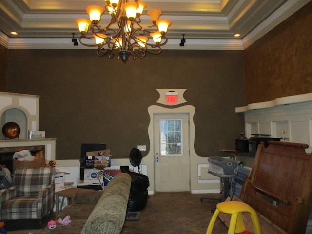 dining area with ornamental molding, an inviting chandelier, and a tray ceiling