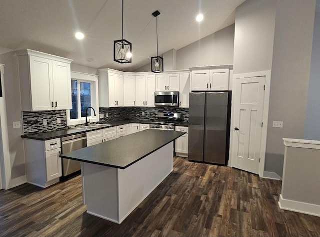 kitchen with sink, hanging light fixtures, stainless steel appliances, white cabinets, and dark hardwood / wood-style flooring