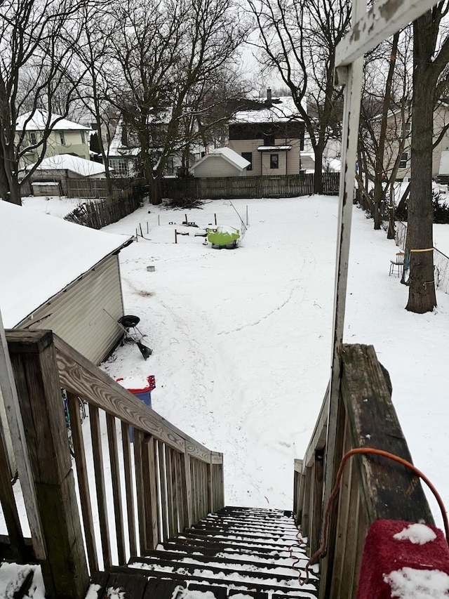 yard layered in snow with fence